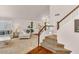 Bright living room featuring a staircase, plush seating, and stylish decor at 4402 E Barwick Dr, Cave Creek, AZ 85331