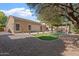 Spacious backyard with a cozy pergola, seating area, and manicured landscaping for outdoor enjoyment at 4667 E County Down Dr, Chandler, AZ 85249