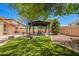 Beautiful backyard features a pergola with a seating area and lush landscaping, perfect for relaxation at 4667 E County Down Dr, Chandler, AZ 85249