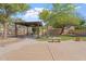 Lush backyard featuring a shaded pergola with outdoor seating, perfect for entertaining and relaxation at 4667 E County Down Dr, Chandler, AZ 85249