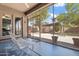 Relaxing screened-in porch with a rocking chair overlooking the private backyard and covered patio at 4667 E County Down Dr, Chandler, AZ 85249