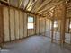 Exposed framing in this unfinished bedroom shows window and door placements with insulation installed at 46868 W Coe St, Maricopa, AZ 85139