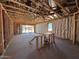 Unfinished living room with exposed framing shows floor plan and window/door placement at 46868 W Coe St, Maricopa, AZ 85139