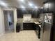 Kitchen showcases dark cabinets, stainless appliances, tile flooring, and granite countertops at 5110 N 42Nd Dr, Phoenix, AZ 85019