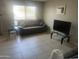 Cozy living room with tile floors, neutral paint, large windows, and glass end tables at 5110 N 42Nd Dr, Phoenix, AZ 85019