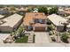 Aerial view of the property and surrounding neighborhood with lush landscaping and tile roofs at 5211 W Wikieup Ln, Glendale, AZ 85308