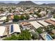 An aerial view of a residential neighborhood with homes, solar panels, and pool at 5211 W Wikieup Ln, Glendale, AZ 85308
