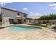 Inviting backyard featuring a pool, outdoor dining, and relaxing hammock space at 5211 W Wikieup Ln, Glendale, AZ 85308