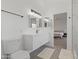 Modern bathroom with floating vanity, dual mirrors, and gray tile floor at 5211 W Wikieup Ln, Glendale, AZ 85308