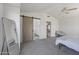 Primary bedroom featuring a sliding barn door to ensuite bath and vaulted ceilings at 5211 W Wikieup Ln, Glendale, AZ 85308