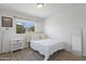 Bright bedroom features a bed with white bedding and a window with natural light at 5211 W Wikieup Ln, Glendale, AZ 85308