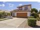 Two-story home with a two-car garage, driveway, and manicured landscaping at 5211 W Wikieup Ln, Glendale, AZ 85308