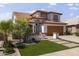 Charming two-story home featuring a well-maintained front yard and attached two-car garage at 5211 W Wikieup Ln, Glendale, AZ 85308