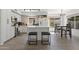 Bright, modern kitchen with white cabinets, center island, stainless steel appliances, and a dining area at 5211 W Wikieup Ln, Glendale, AZ 85308