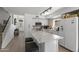 Modern kitchen features white cabinets, granite countertops, stainless appliances, and a center island with seating at 5211 W Wikieup Ln, Glendale, AZ 85308