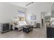 Open-concept living room featuring natural light, comfortable seating, modern décor and wood-look tile flooring at 5211 W Wikieup Ln, Glendale, AZ 85308
