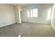 Bright bedroom with neutral carpet and large windows providing natural light at 5645 S 253Rd Ave, Buckeye, AZ 85326