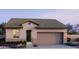Inviting single-story home featuring a two-car garage, neutral stucco siding, and a well-manicured front garden at 5645 S 253Rd Ave, Buckeye, AZ 85326