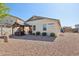 Exterior view of a home with a gazebo-covered seating area and a well-maintained gravel backyard at 5724 N 108Th Ave, Phoenix, AZ 85037