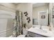 Bathroom featuring a shower-tub combo, and a modern vanity with a decorative mirror at 5724 N 108Th Ave, Phoenix, AZ 85037