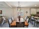 Dining area with a wooden table adjacent to kitchen with backyard view at 5724 N 108Th Ave, Phoenix, AZ 85037