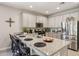 Open kitchen with bar seating, stainless steel appliances, granite counters, and ample cabinet space at 5724 N 108Th Ave, Phoenix, AZ 85037