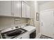 Well-equipped laundry room with modern washer and dryer, and plenty of cabinet space for storage at 5724 N 108Th Ave, Phoenix, AZ 85037