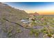 Aerial view showcasing the home, pool, surrounding desert landscape, and stunning mountain views at 6432 E El Sendero Rd, Carefree, AZ 85377