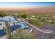 A backyard pool is surrounded by lush landscaping in this aerial view of a desert home at 6432 E El Sendero Rd, Carefree, AZ 85377