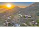 Aerial view of luxury homes nestled in the desert mountainside at sunset at 6432 E El Sendero Rd, Carefree, AZ 85377