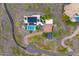 Aerial view of property with a pool, solar panels, manicured landscaping, and circular driveway at 6432 E El Sendero Rd, Carefree, AZ 85377