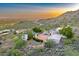 Aerial view of a desert property showing the house nestled in the mountains at 6432 E El Sendero Rd, Carefree, AZ 85377