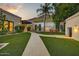 A private backyard with lush landscaping, mature trees, and seating at 6432 E El Sendero Rd, Carefree, AZ 85377