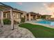 Backyard featuring an outdoor lounge area, a pristine pool, an artificial lawn and desert landscaping at 6432 E El Sendero Rd, Carefree, AZ 85377