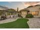 Backyard showing a patio area with a grill and eating area, as well as decorative artificial grass and desert landscaping at 6432 E El Sendero Rd, Carefree, AZ 85377