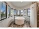 Modern bathroom features a luxurious soaking tub with beautiful natural light at 6432 E El Sendero Rd, Carefree, AZ 85377