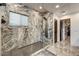 Contemporary bathroom with marble tiling, a rainfall shower, and modern fixtures at 6432 E El Sendero Rd, Carefree, AZ 85377