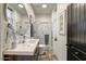 Modern bathroom with a stylish oval mirror, marble shower, and sleek fixtures at 6432 E El Sendero Rd, Carefree, AZ 85377