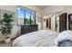 Bright bedroom features a large window with desert views and a cozy, inviting atmosphere at 6432 E El Sendero Rd, Carefree, AZ 85377