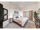 Comfortable bedroom with neutral colors, sliding closet doors, and modern artwork for a serene space at 6432 E El Sendero Rd, Carefree, AZ 85377