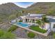 A modern home with solar panels, a pool, mountain views, and a desert landscape at 6432 E El Sendero Rd, Carefree, AZ 85377