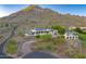 Expansive desert home featuring multiple buildings with modern architecture and lush landscaping at 6432 E El Sendero Rd, Carefree, AZ 85377
