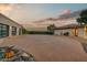 Wide driveway and exterior view of a desert home, showcasing a garage and lush desert landscaping at 6432 E El Sendero Rd, Carefree, AZ 85377