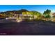 Stunning exterior view of a well-lit home with professional landscaping and private driveway at 6432 E El Sendero Rd, Carefree, AZ 85377