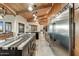 Well-appointed kitchen highlighting wooden cabinets, an island gas range, stainless steel appliances, and modern lighting fixtures at 6432 E El Sendero Rd, Carefree, AZ 85377