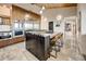 Modern kitchen featuring wooden cabinetry, an island with bar seating, and stainless steel appliances for a gourmet experience at 6432 E El Sendero Rd, Carefree, AZ 85377