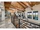 Open living area with wood beam ceilings and a stairway with metal railings at 6432 E El Sendero Rd, Carefree, AZ 85377