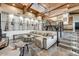 Stylish living area with guitar decorations, wood ceilings and modern staircase at 6432 E El Sendero Rd, Carefree, AZ 85377