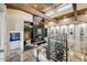A living room with wood beams, fireplace, unique decor, and a modern staircase at 6432 E El Sendero Rd, Carefree, AZ 85377