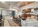 Living room featuring wooden ceiling beams, modern lighting, and a built-in bar area at 6432 E El Sendero Rd, Carefree, AZ 85377